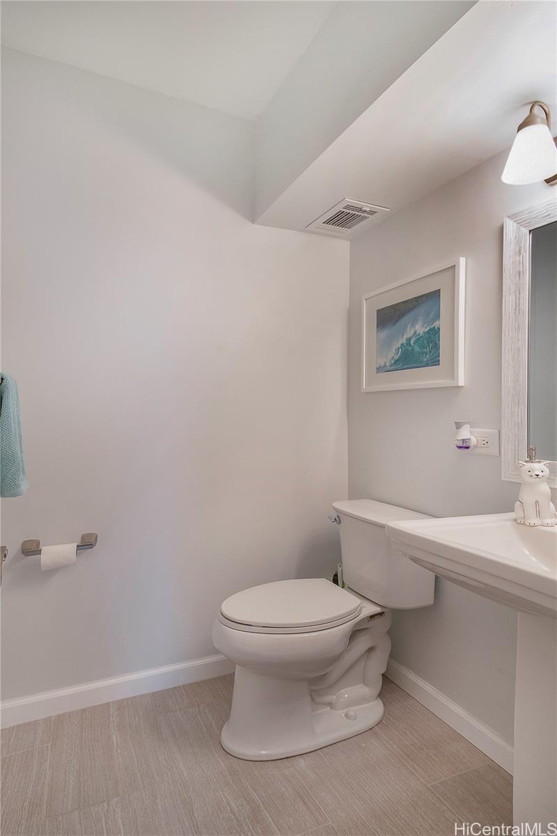 3103 Pualei Circle, Unit 204 Honolulu, HI 96815 - Photo 11 of 17 a white toilet sitting next to a bathroom sink