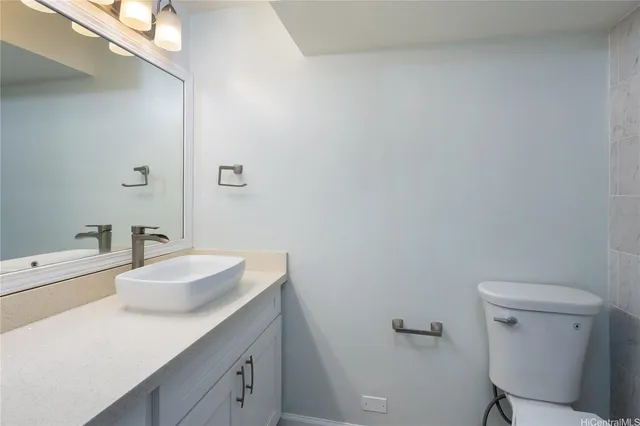 a bathroom with a sink toilet and a mirror
