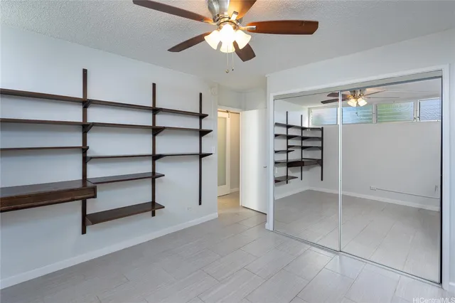 a view of a livingroom with furniture and a ceiling fan