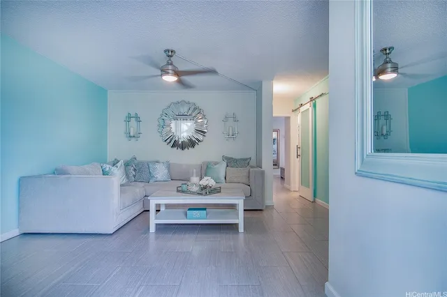 a living room with furniture and a chandelier