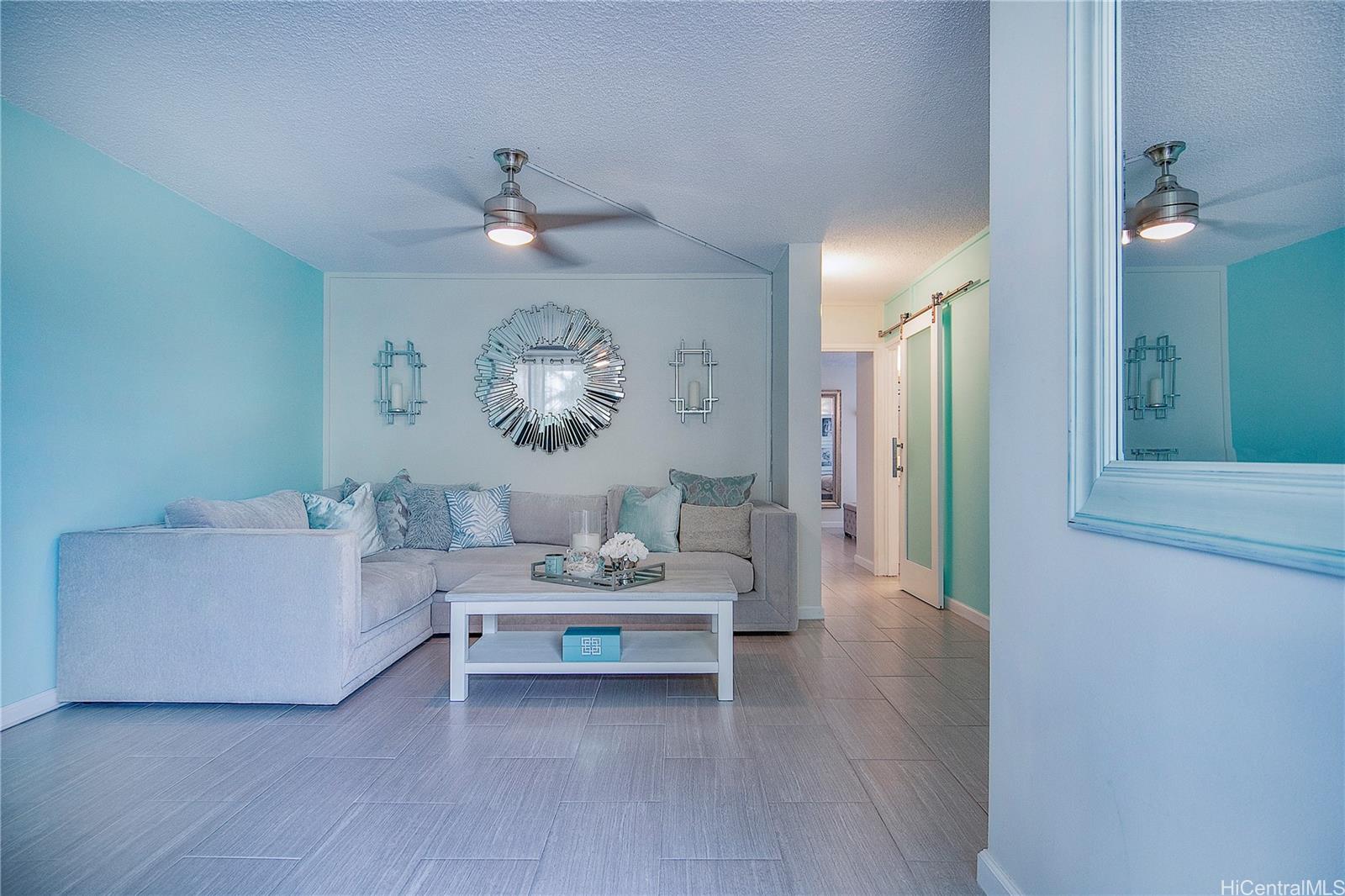3103 Pualei Circle, Unit 204 Honolulu, HI 96815 - Photo 2 of 17 a living room with furniture and a chandelier
