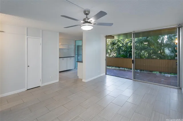 a view of a livingroom with a ceiling fan and window