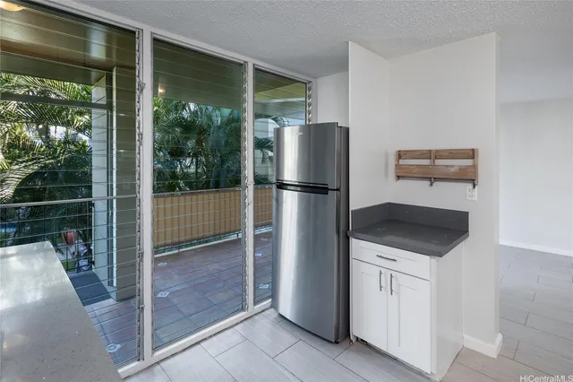 a kitchen with a refrigerator and a sink