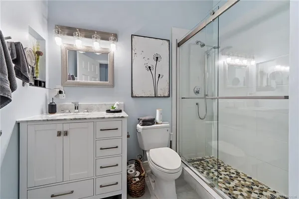a bathroom with a toilet and a shower