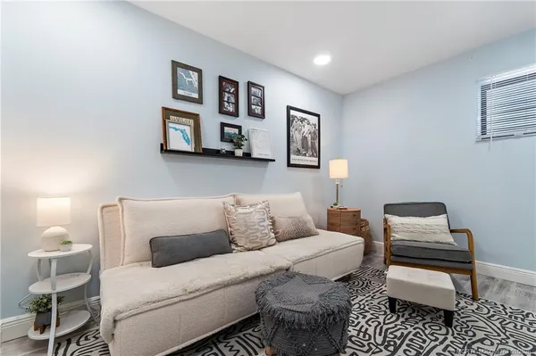 a living room with furniture a rug and a large window