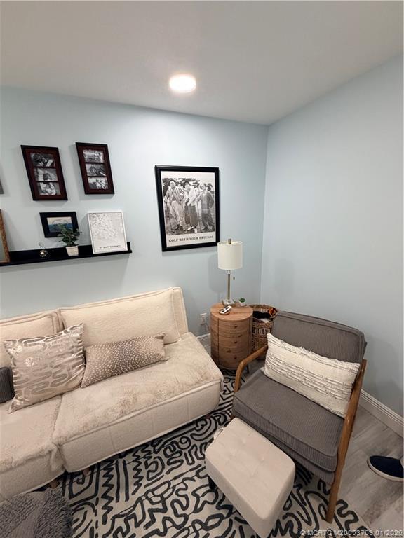 310 Southeast Denver Avenue, Unit 2 Stuart, FL 34994 - Photo 2 of 8 a living room with furniture and a chair