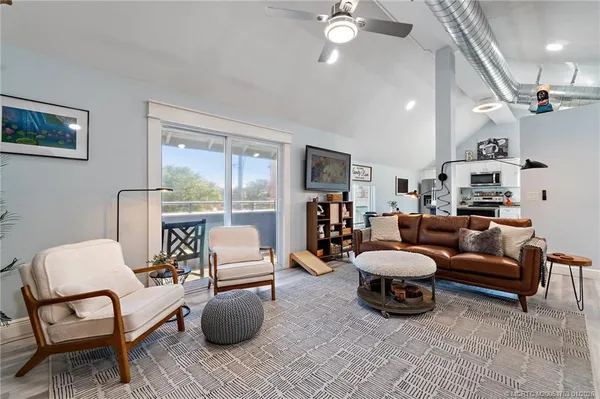 a living room with furniture and a large mirror