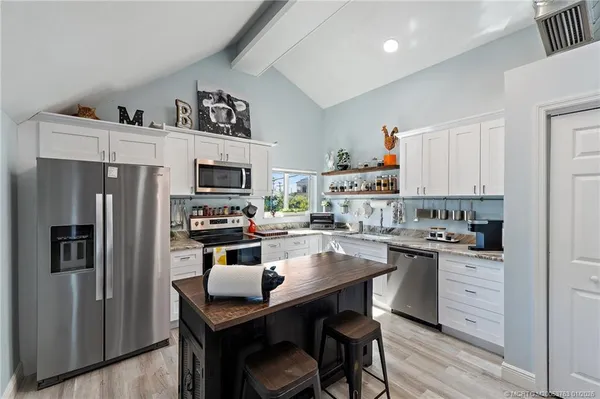 a kitchen with a stove a sink and a refrigerator