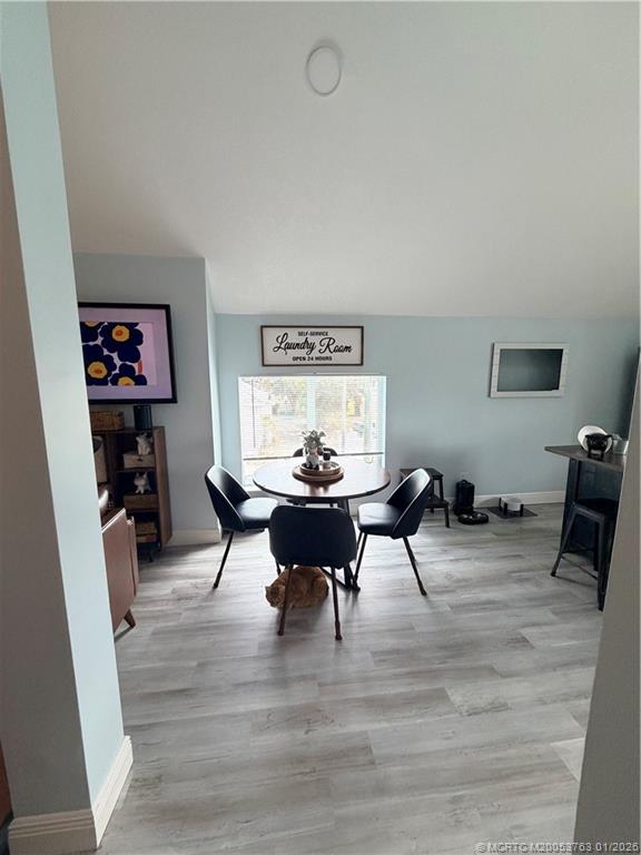310 Southeast Denver Avenue, Unit 2 Stuart, FL 34994 - Photo 3 of 8 a view of a dining room with furniture and wooden floor