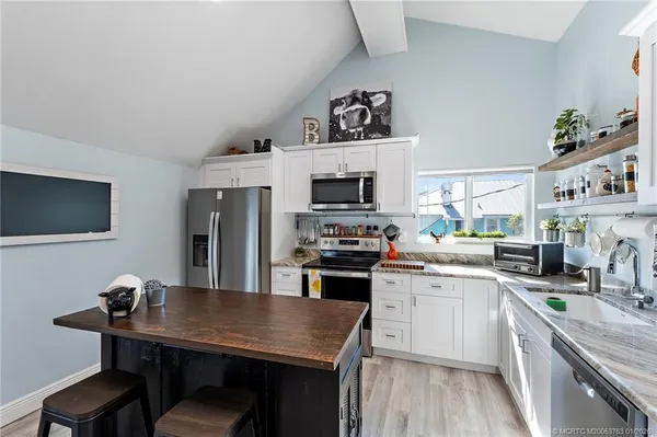 a kitchen with stainless steel appliances granite countertop a stove and a sink