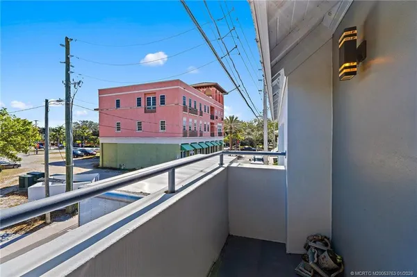 a balcony with table and chairs