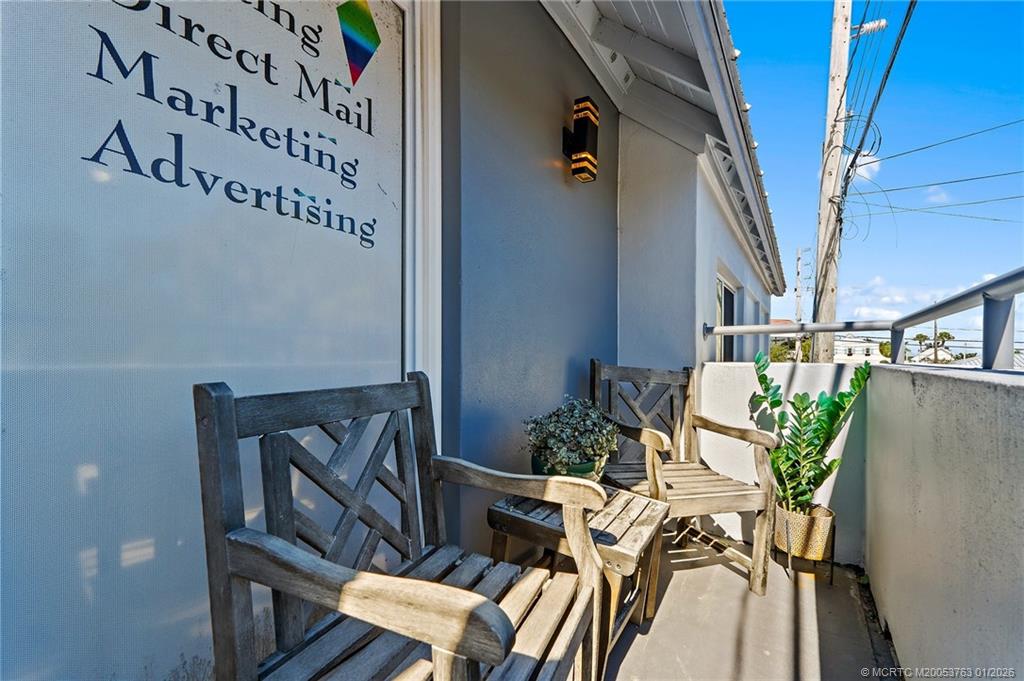 310 Southeast Denver Avenue, Unit 2 Stuart, FL 34994 - Photo 50 of 50 a balcony with table and chairs