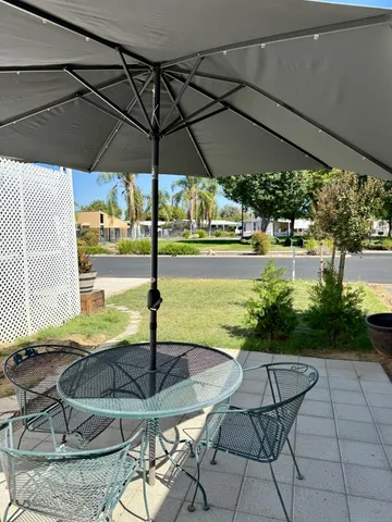 a view of a chairs and table in the patio