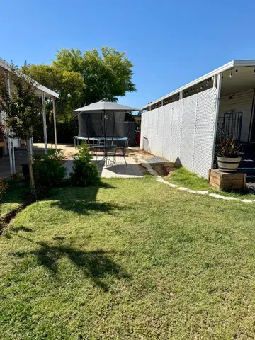 a view of a backyard with sitting area