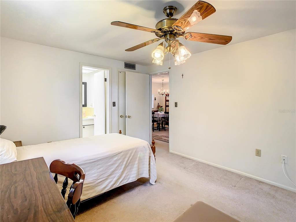4230 Redcliff Place, Unit 4230 New Port Richey, FL 34652 - Photo 12 of 42 a bedroom with a bed chandelier and a window