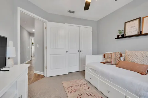 a living room with furniture and a book shelf