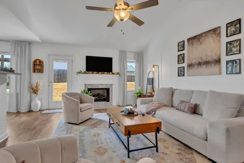 a living room with furniture and a potted plant