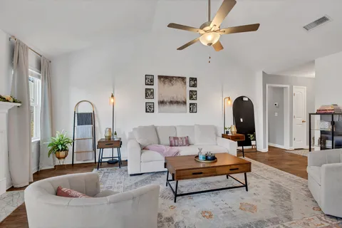a living room with furniture a fireplace and a flat screen tv