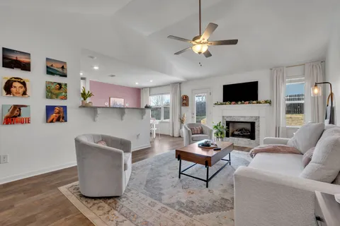 a living room with furniture and kitchen view