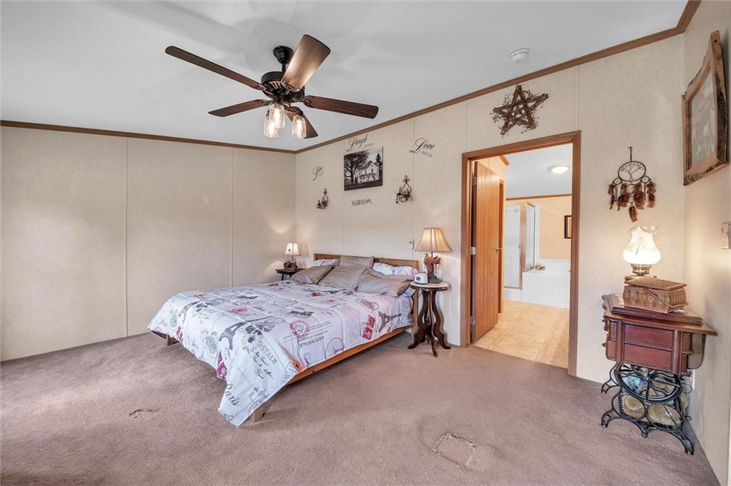 303 Wilhelm Road Rural Valley, PA 16249 - Photo 19 of 25 a bedroom with a bed and a chandelier