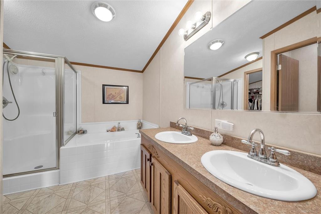 303 Wilhelm Road Rural Valley, PA 16249 - Photo 20 of 25 a bathroom with a double vanity sink mirror and bathtub