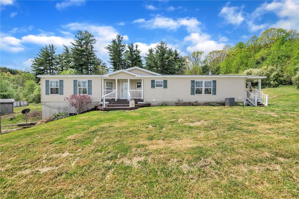 303 Wilhelm Road Rural Valley, PA 16249 - Photo 2 of 25 a house view with a garden space