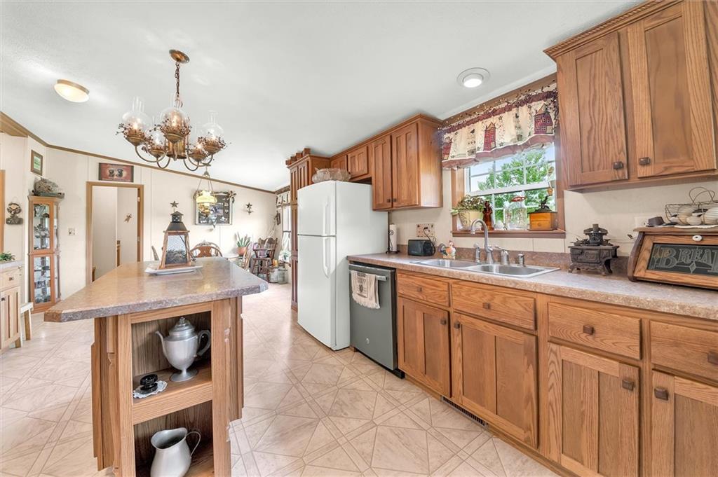 303 Wilhelm Road Rural Valley, PA 16249 - Photo 9 of 25 a kitchen with stainless steel appliances granite countertop a refrigerator and a sink