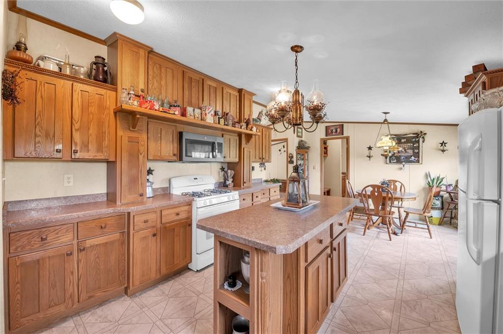 303 Wilhelm Road Rural Valley, PA 16249 - Photo 10 of 25 a kitchen that has a lot of cabinets a sink and wooden floor