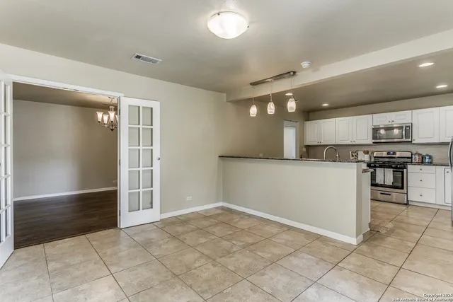 a view of kitchen with microwave and cabinets