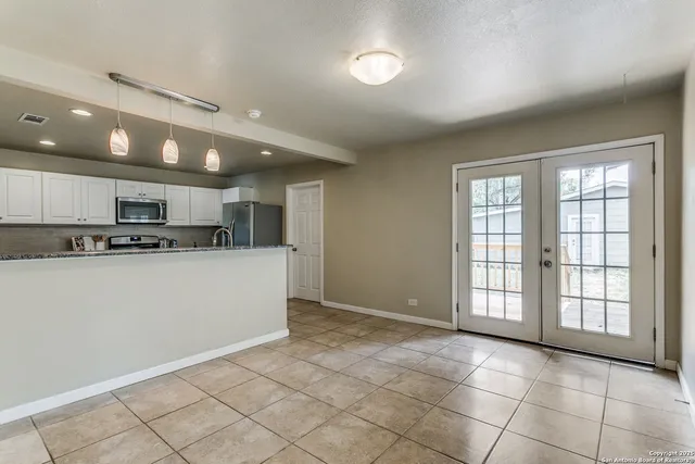 a view of a kitchen with an empty space and a window