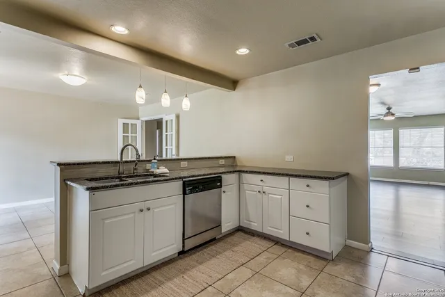 a large bathroom with a granite countertop double vanity sink and a mirror