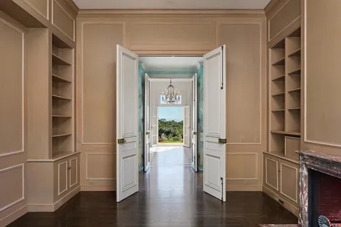 a view of walk in closet with wooden floor and windows