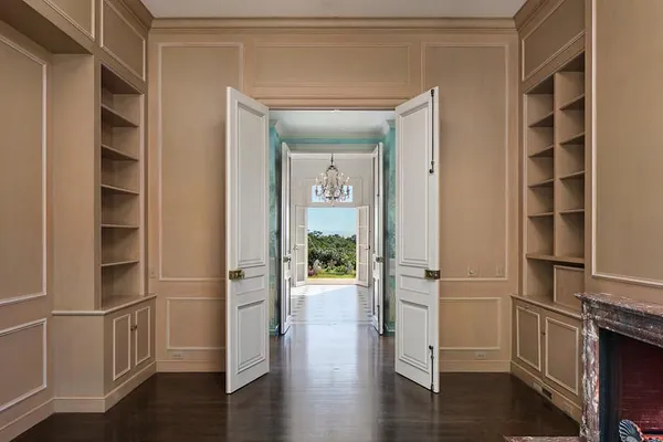 a view of walk in closet with wooden floor and windows
