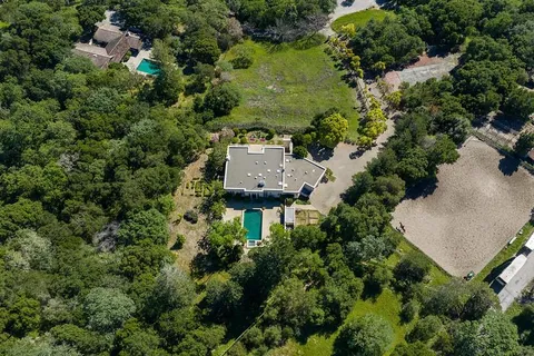 an aerial view of a house with a yard