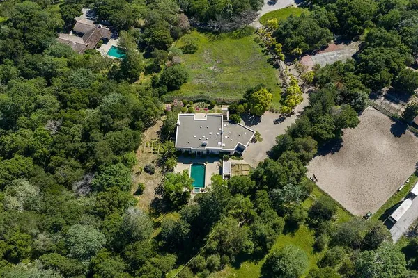 an aerial view of a house with a yard