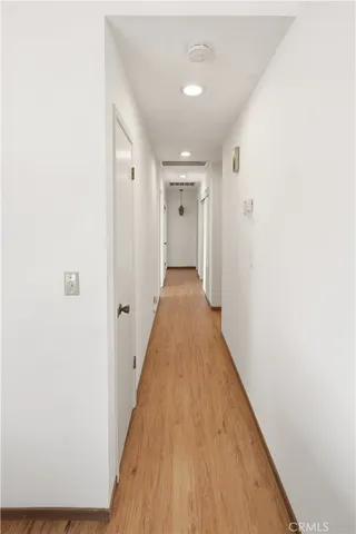 a view of a house with a yard and large tree