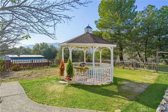 an aerial view of a house with a yard and garden