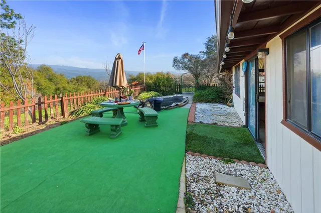an aerial view of house with yard and mountain view in back