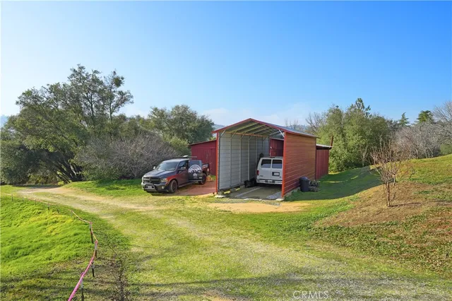 an aerial view of house with yard and mountain view in back