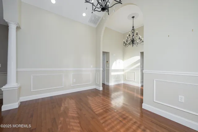 a view of a livingroom with wooden floor and a fireplace