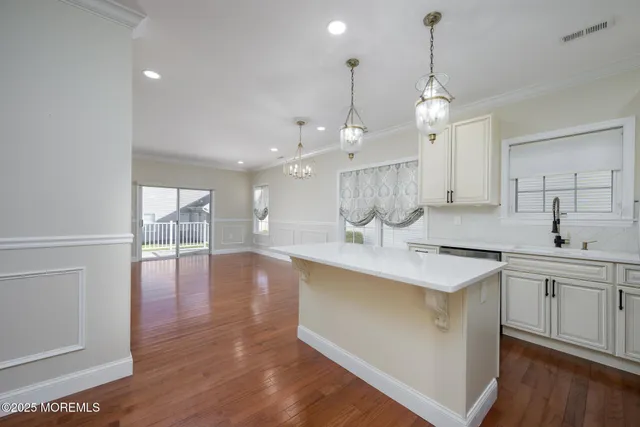 a kitchen with a stove and a wooden floor