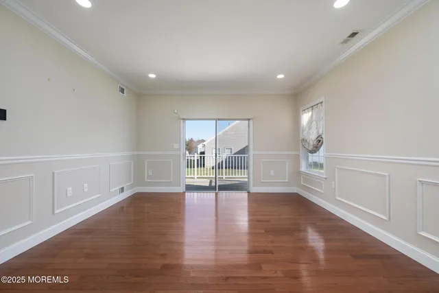 a bedroom with bed couches and a flat tv screen
