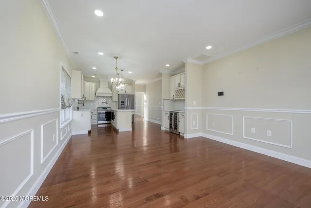 a spacious bedroom with a bed and a flat screen tv