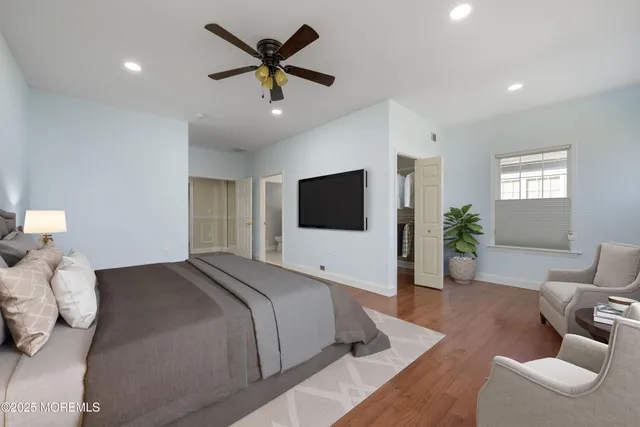 a view of a hallway with wooden floor and closet