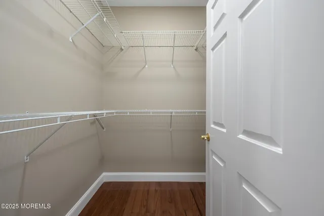 a view of a large house with a big yard and large trees