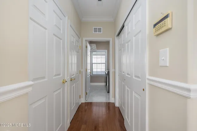 a front view of a house with a yard and potted plants