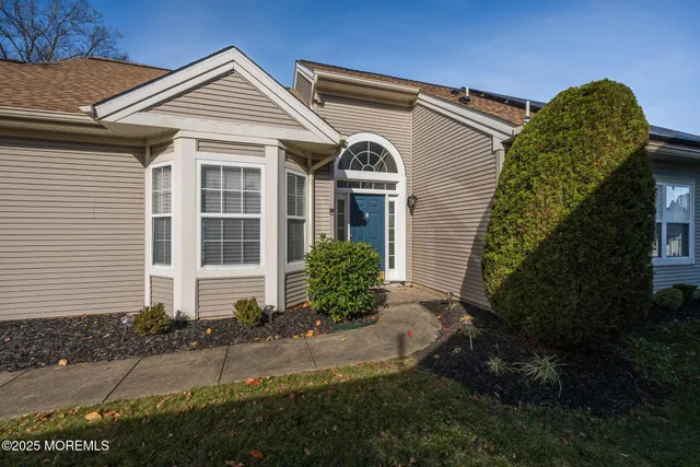 a view of a room with a window and wooden floor