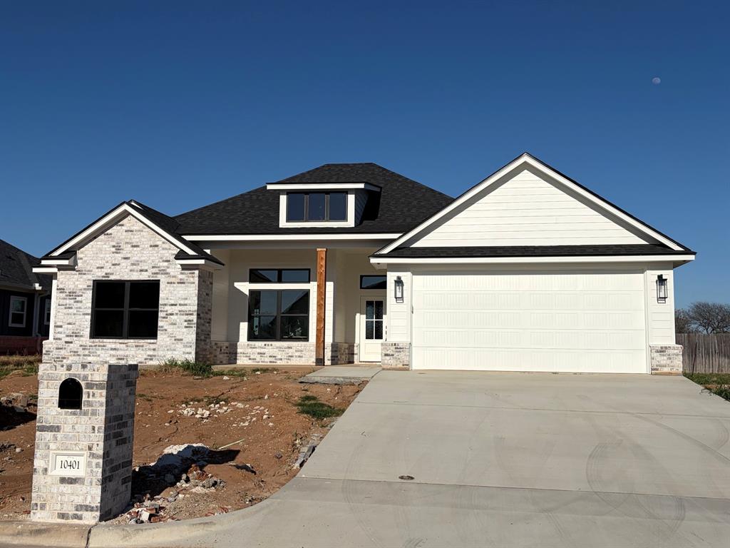 10401 T T Bury Lane Waco, TX 76708 - Photo 1 of 16 View of front facade with a porch, a garage, concrete driveway, and brick siding