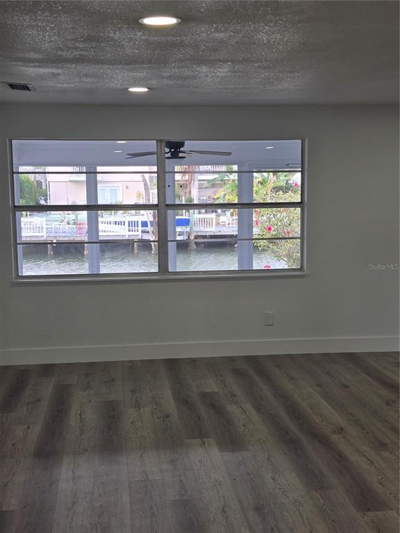 13737 Michelle Avenue Hudson, FL 34667 - Photo 13 of 25 view of empty room with wooden floor and fan