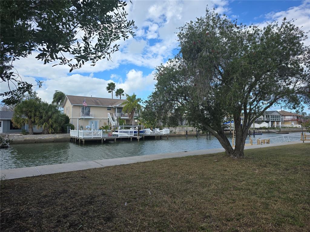 13737 Michelle Avenue Hudson, FL 34667 - Photo 21 of 25 a view of a house with a yard and a large tree